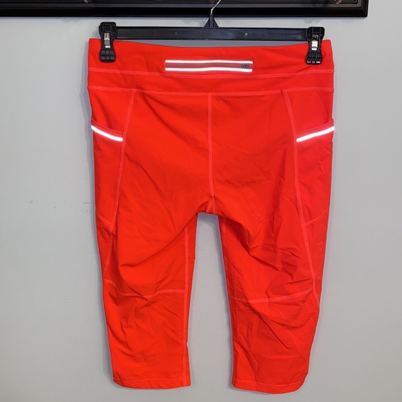 Athleta NWOT orange, thin leggings with side pockets, zip packet size Medium - Picture 5 of 7